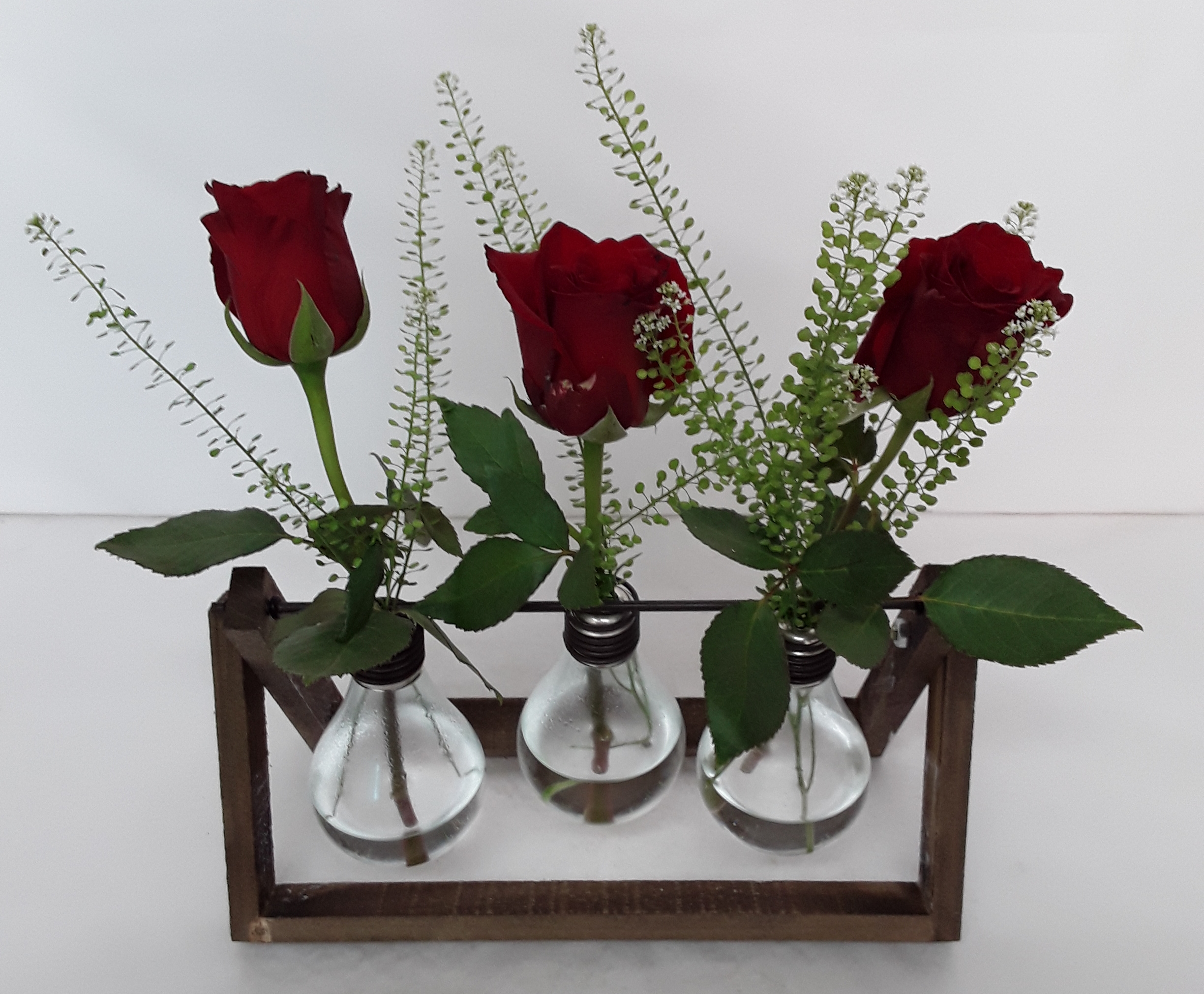 Fresh roses in wooden creation
