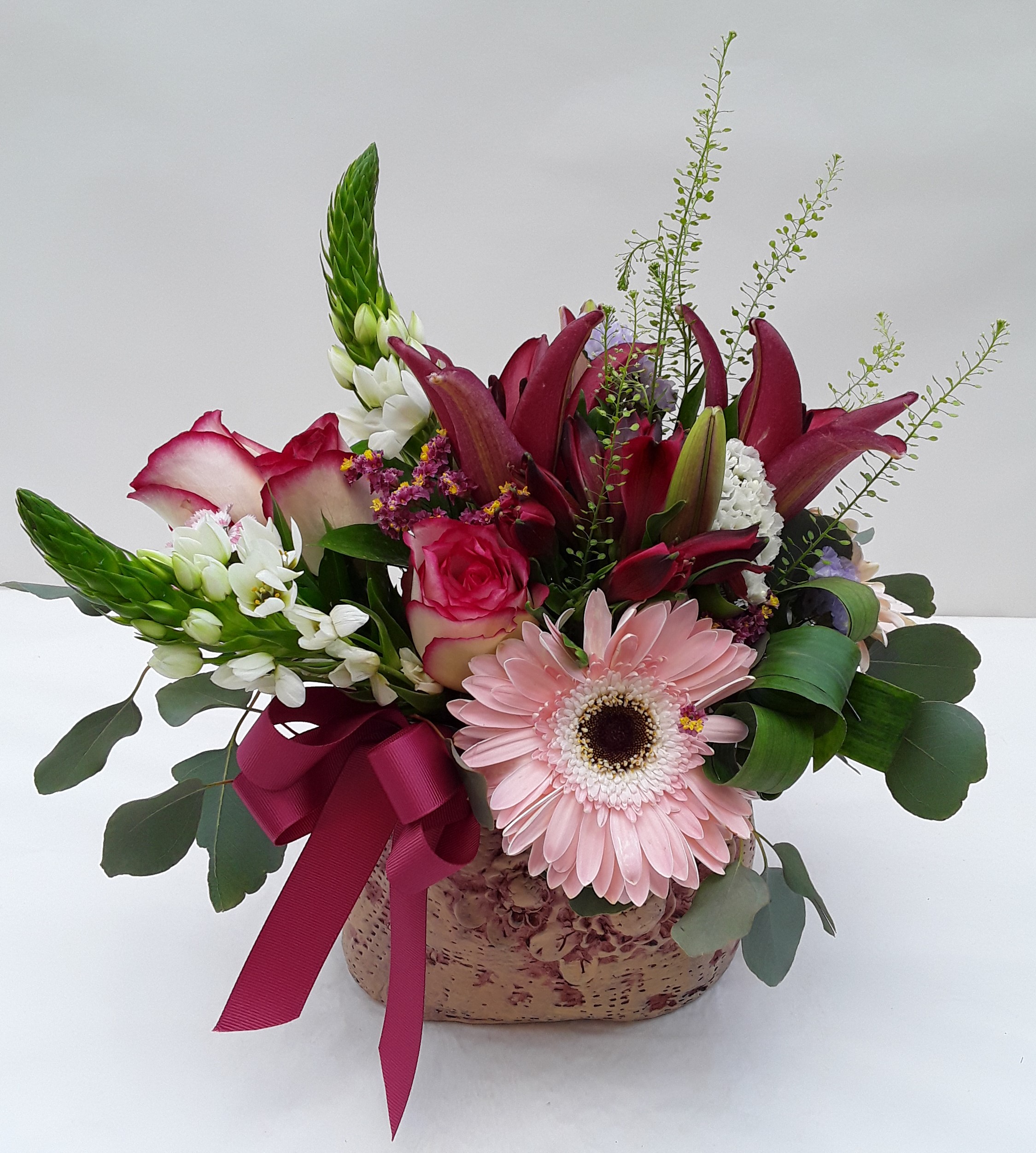 Mixed flowers in clay pot