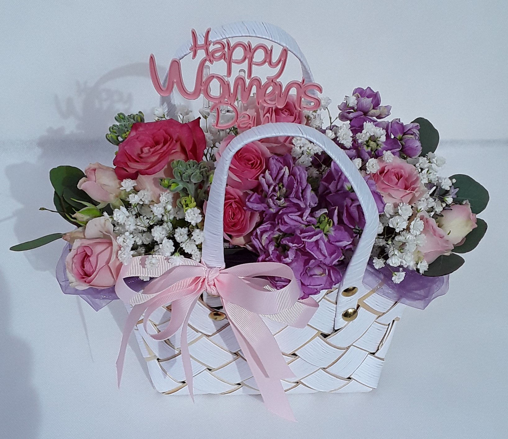 White bag mixed seasonal flowers