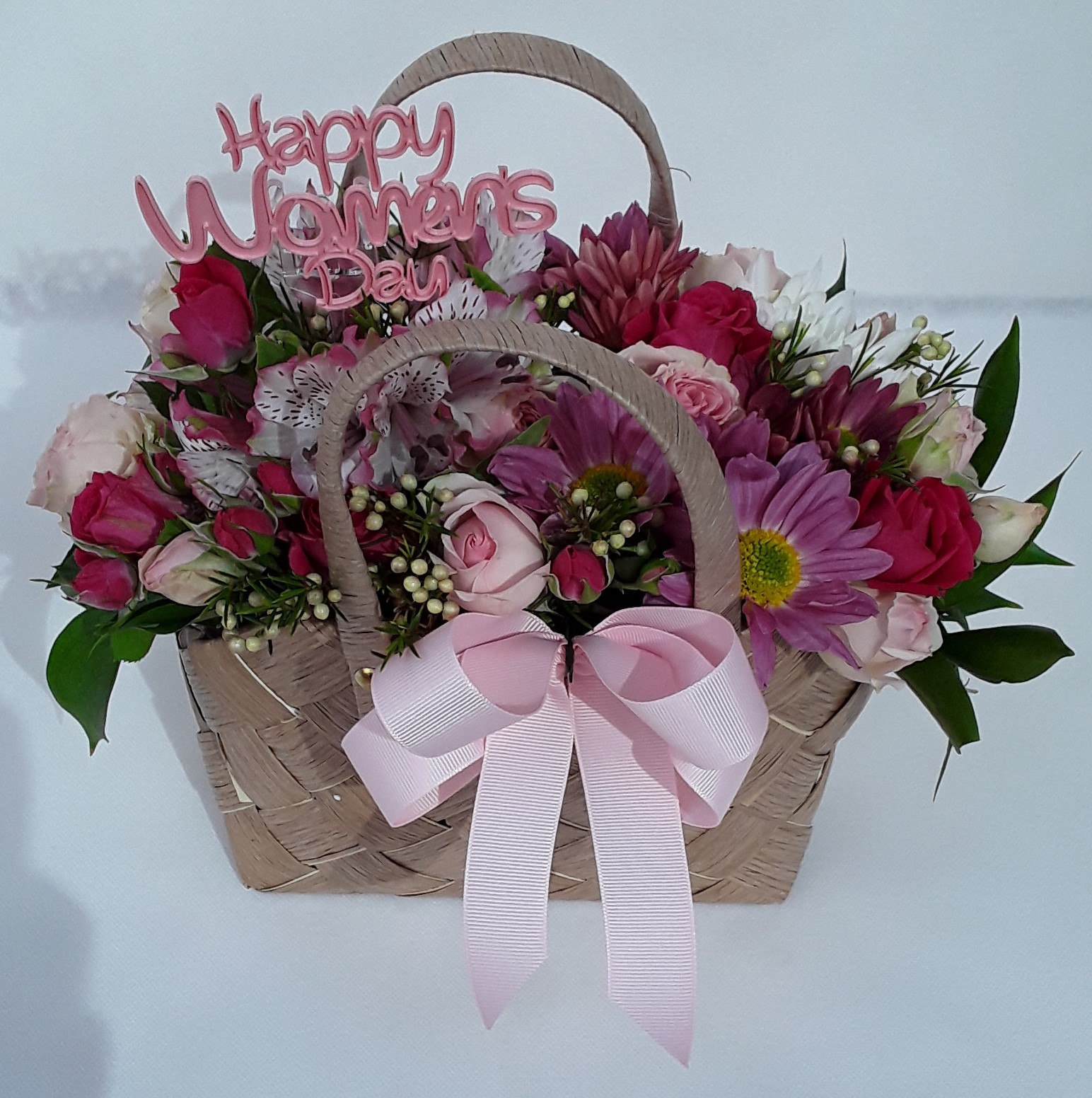 Beige bag mixed seasonal flowers