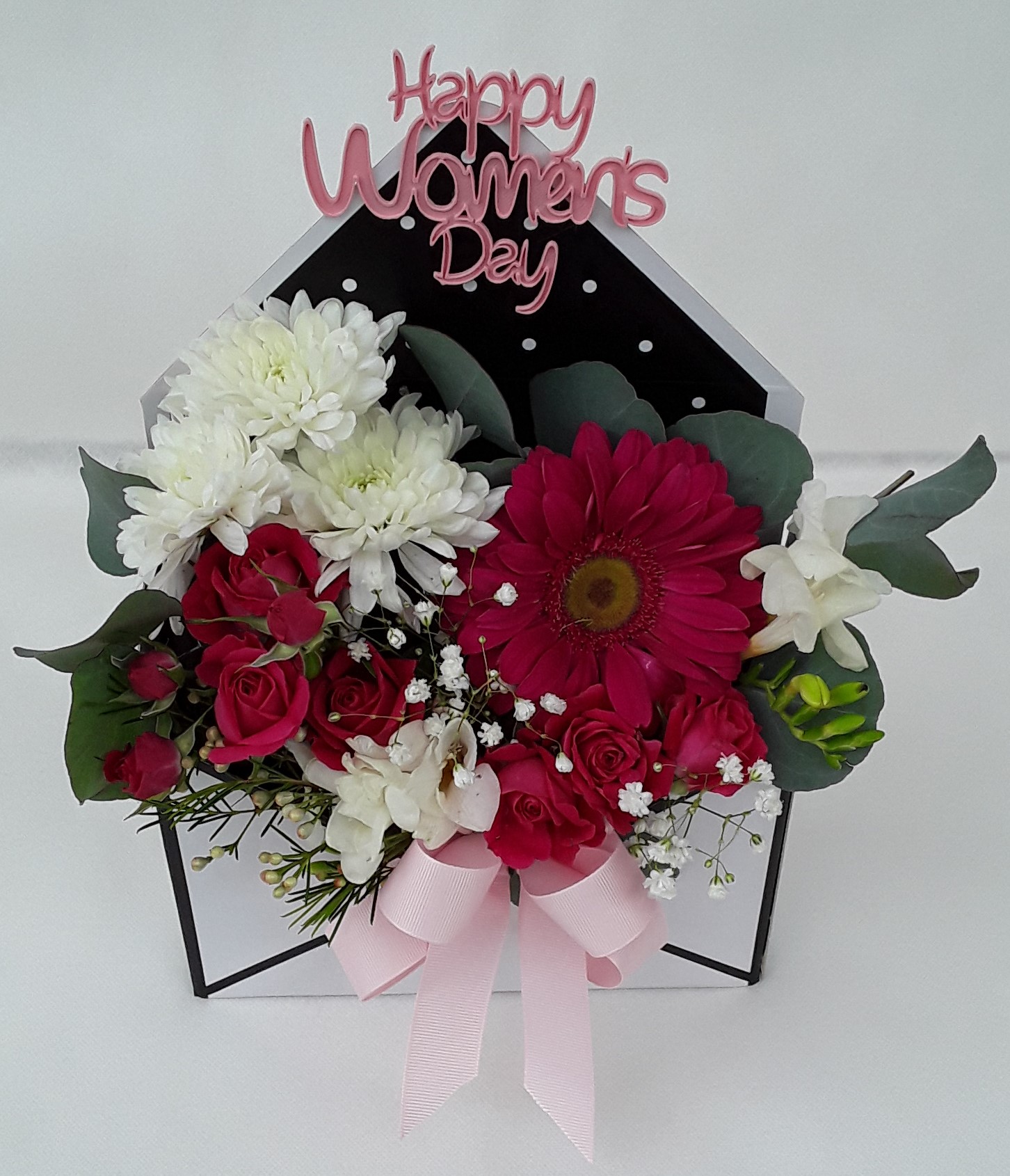 White letter box with mixed flowers