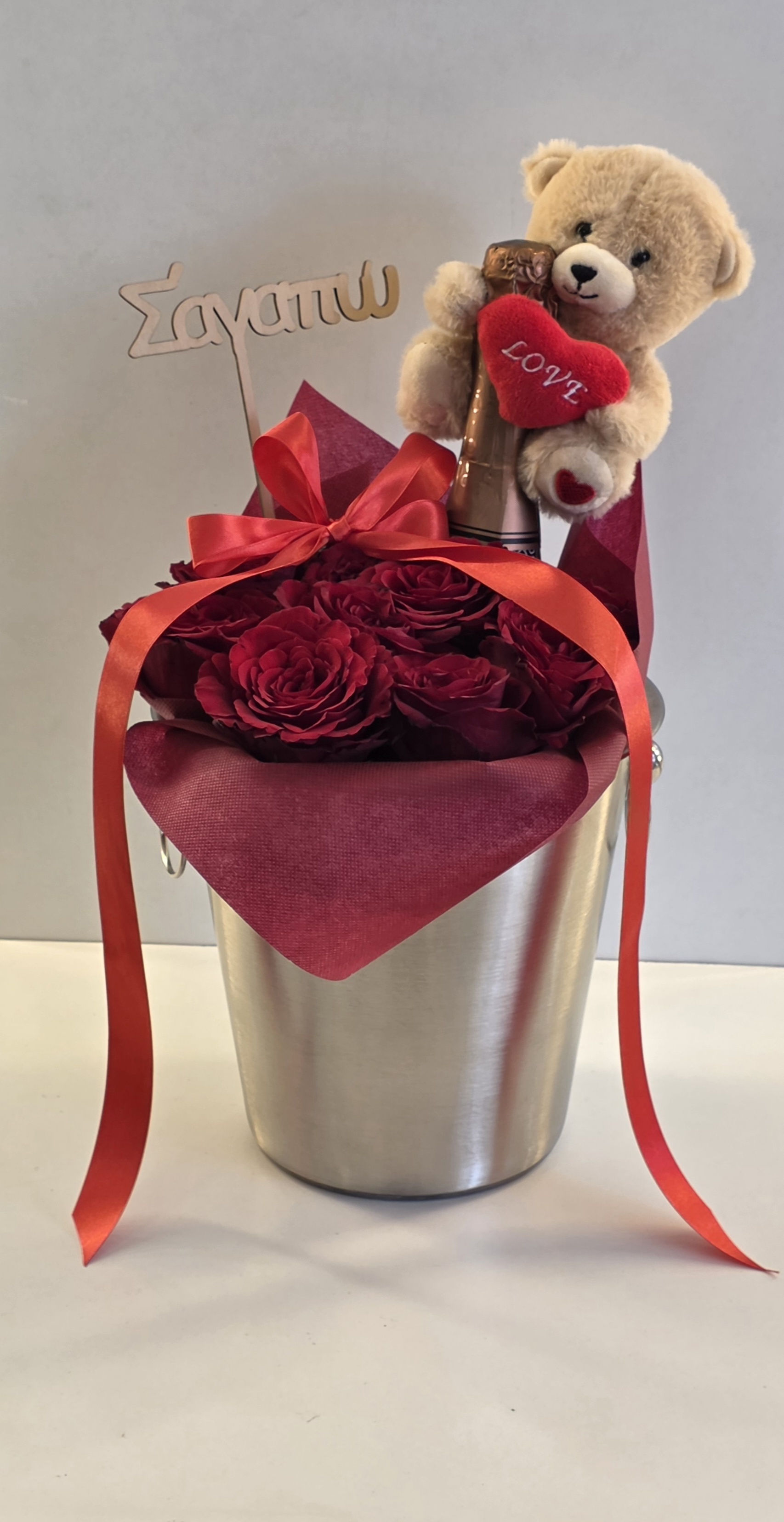 1Big Champaign ,1 Small Tady Bear,1 Card,First Quality Of 11-13 Roses & 1 Ice Bucket