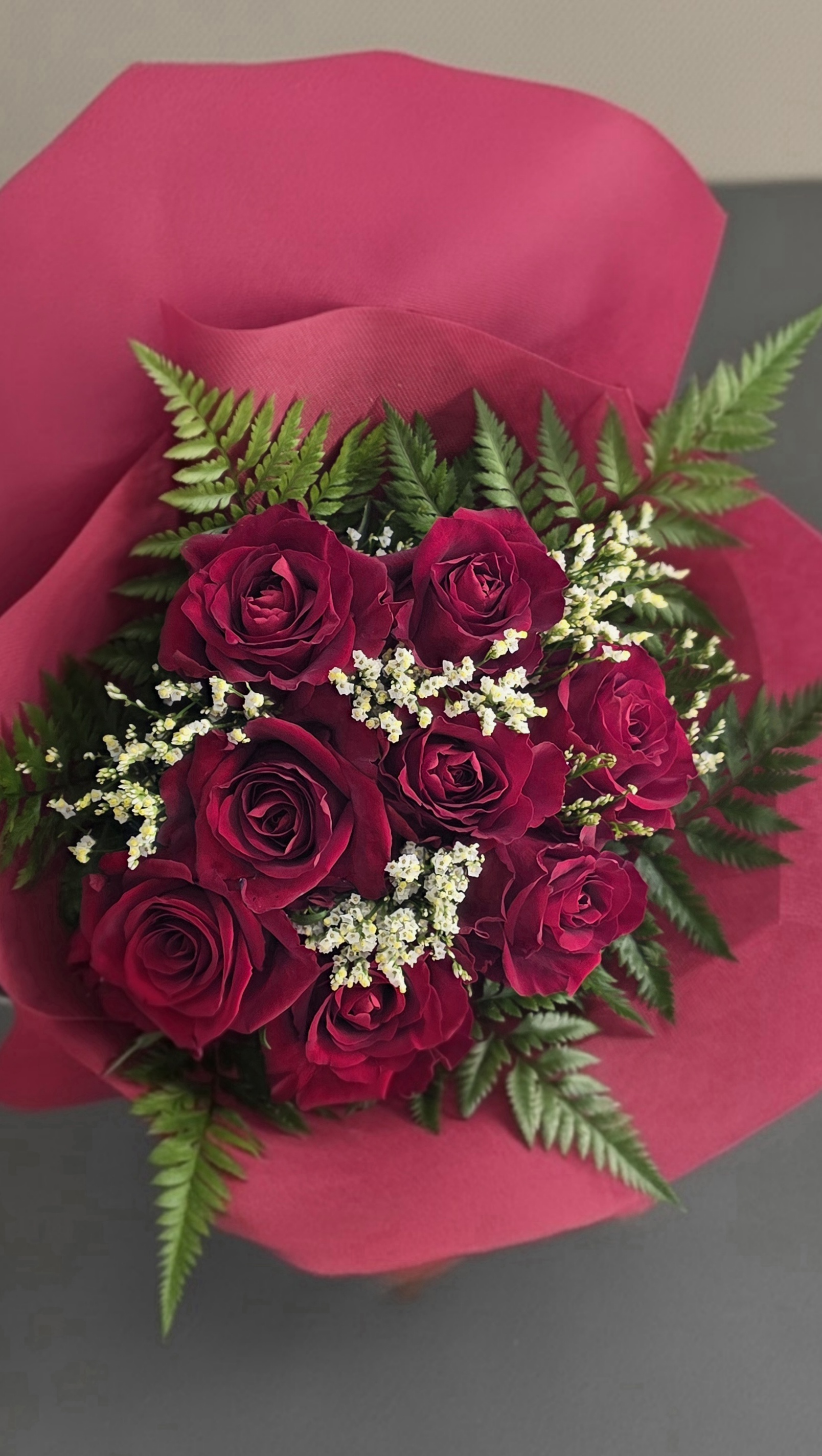 9 First Quality Red Roses With Seasonal Greenery