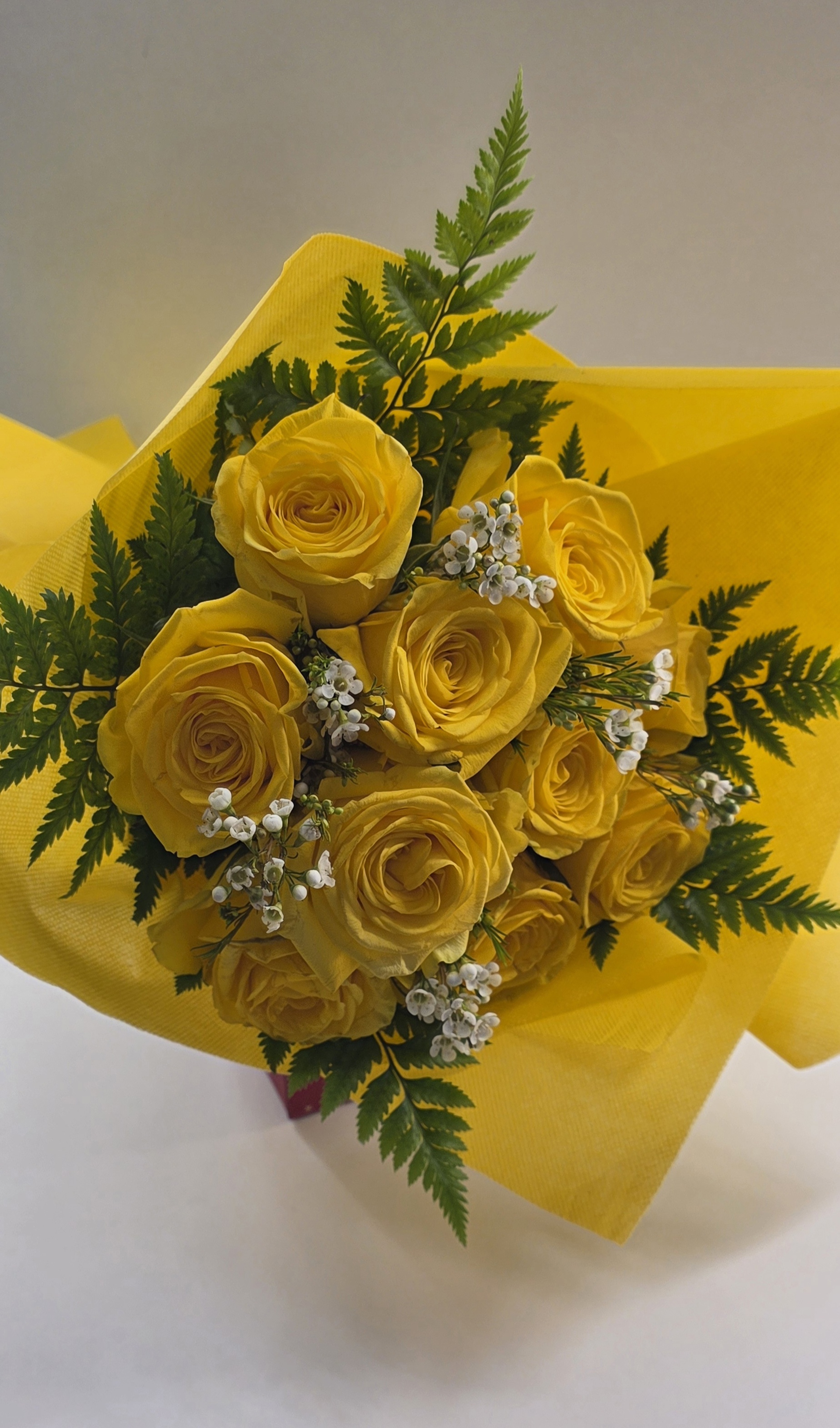 9 First Quality Yellow Roses With Seasonal Greenery