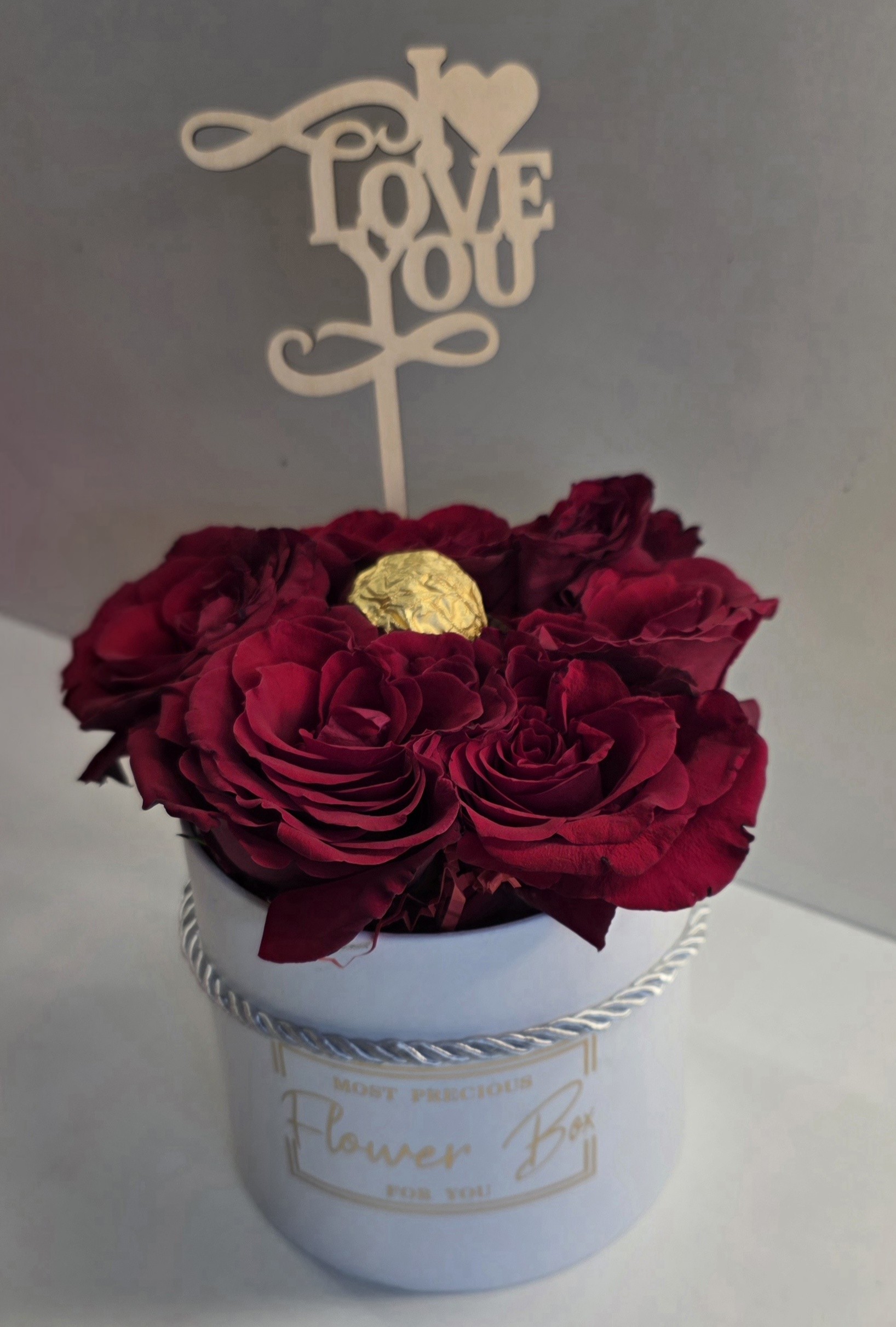 1 Ferrero Rocher with 5-7 first quality fresh red roses with love stick in a small box No.6029