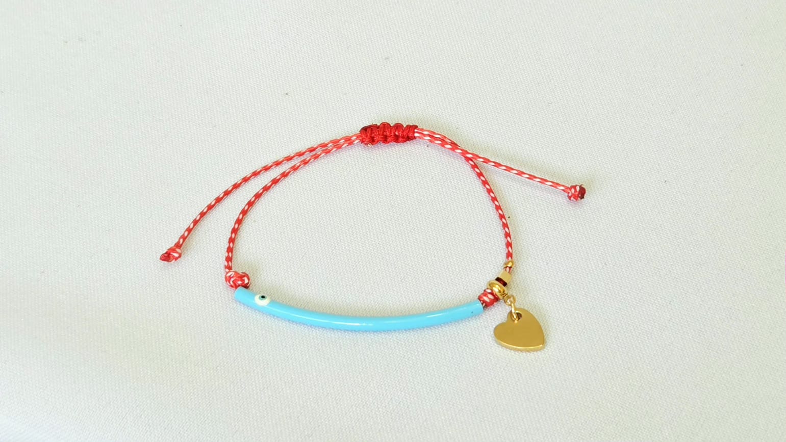 Martaki With Blue Tube With Eye And A Stainless Steel Hanging Heart.