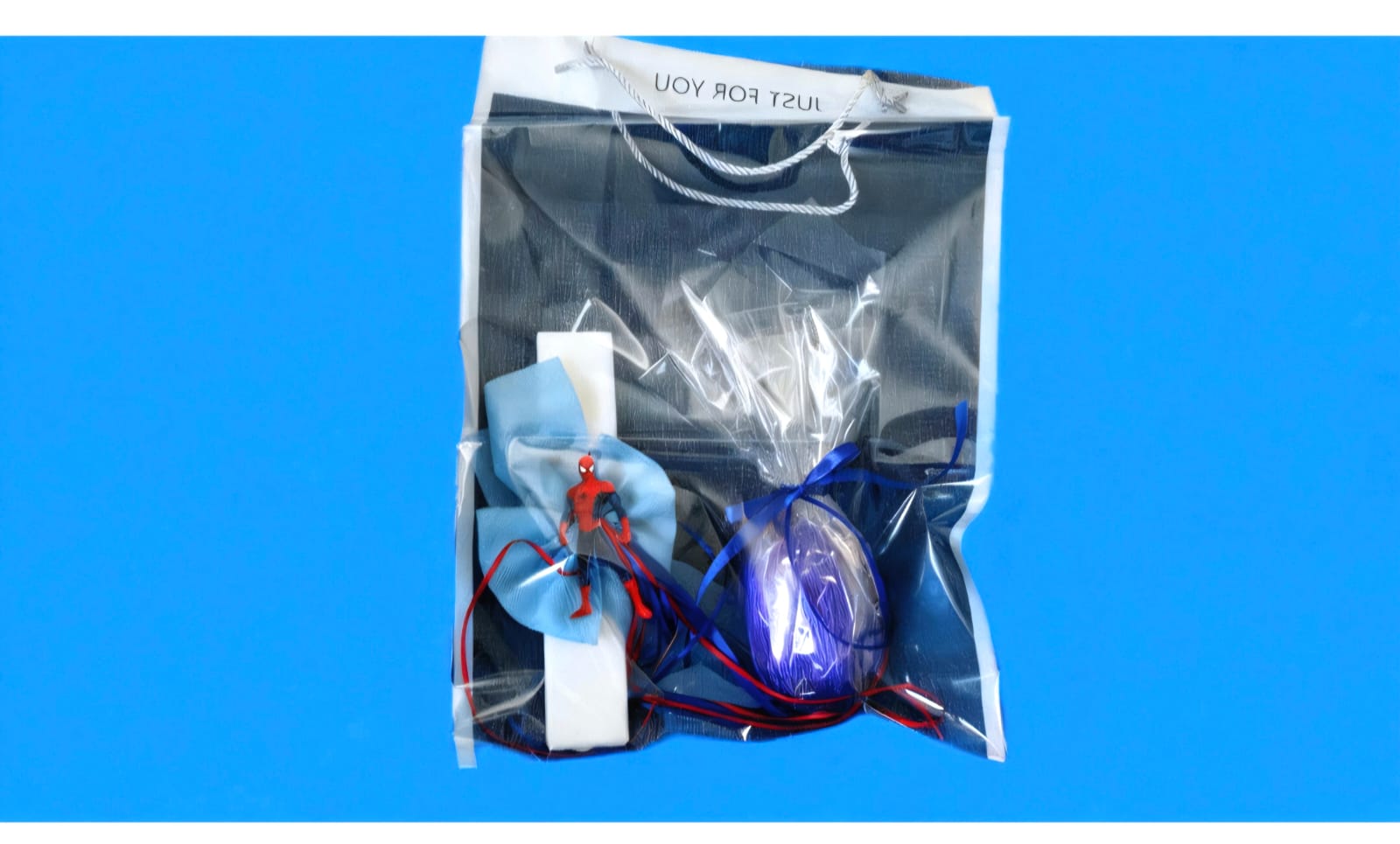 EASTER CANDLE WITH SPADERMAN DECORATION AND CHOCOLATE EGG.