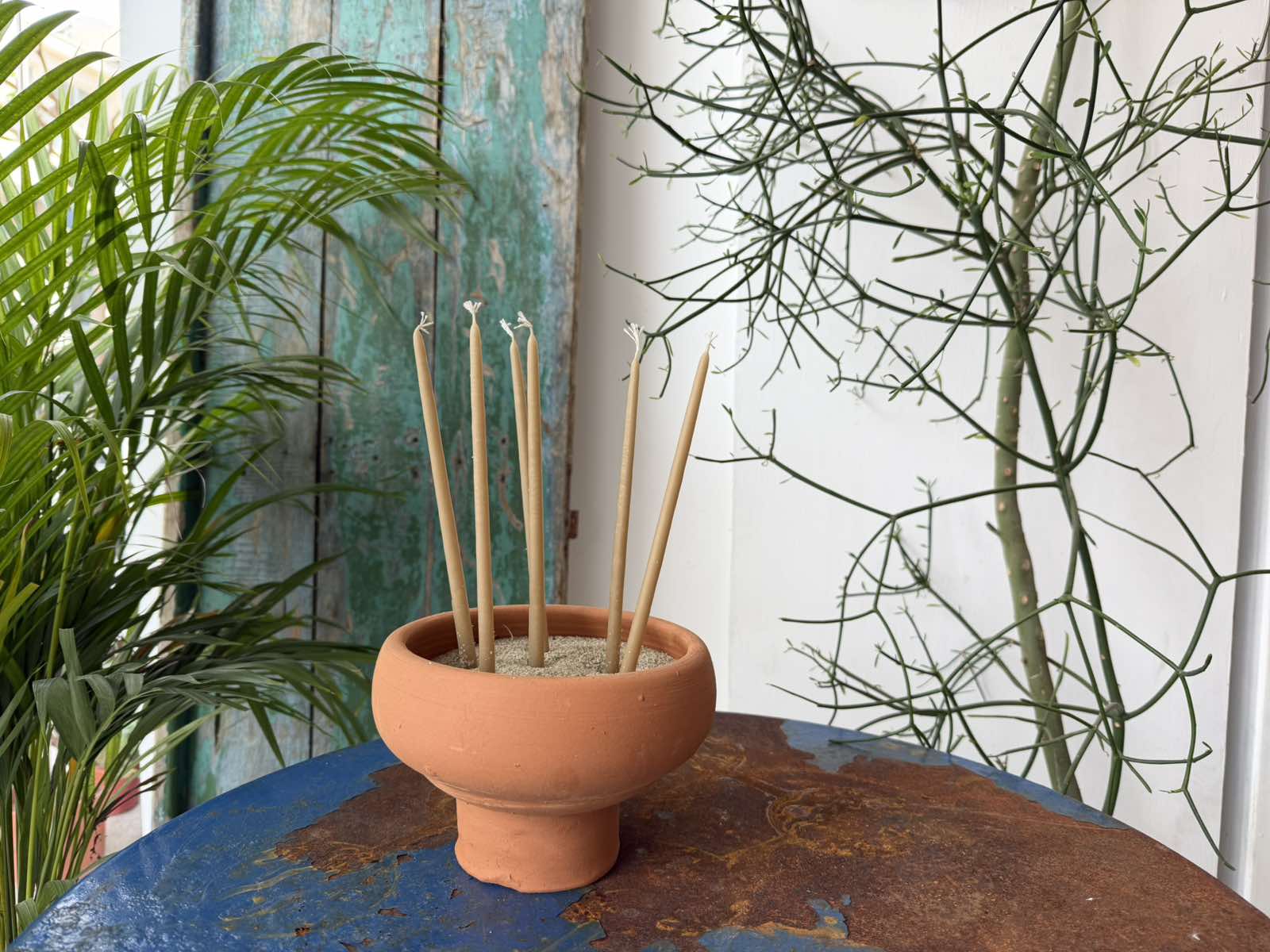 Terracotta bowl with sand and beeswax candles